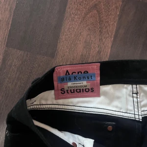 Svarta skinny jeans Acne Studios - Svarta jeans från Acne Studios Blå Konst med klassisk femficksmodell och smal passform. Jeansen har en stilren look med svarta sömmar och knappstängning.. W30 L32