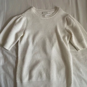 Vit stickad tröja från Vila - Säljer en vit stickad tröja från Vila med korta puffärmar och rund halsringning. Passar storlekarna Xs,S,M