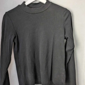 Black short turrleneck - Size M fits L short turtleneck shirt. Used a few times.