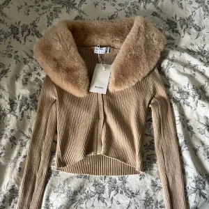 Topp med fluff - Säljer denna helt nya toppen med prislapp kvar. Går att ta av fluffet (kragen) med hjälp av knapparna (bild 4)