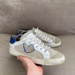 Philippe Model skor - Ett par sjukt snygga Philippe Model, storlek 45, passar även 46! Färg: vit med blå bak! Perfekta sommarskor ☀️🌼Hör av er vid frågor! 