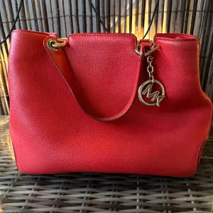 Red handbag from Michael Kors. Used but still good condition. A few flaws as shown in pictures 
