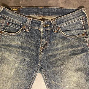 Lågmidjade bootcut Lee jeans - Säljer dessa supersnygga Lee jeans som tyvärr blivit för små för mig. De är i en jättefin färg av blå som gör att de matchar bra med mycket! Skulle säga att de passar bäst på xs. Kontakta mig för mer info💗