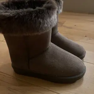 Ett par vattentäta stall uggs som kan användas till vardags också. Från hkm. De är i en brun/beige färg med fluff. Använda ca 2 gånger då de är för små. 