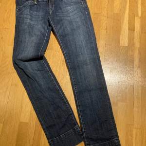 Mörkblå oanvända jeans  Bred linning med tre knappar 