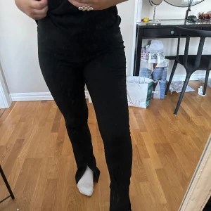 Utsvängda kostymbyxor - Säljer dessa svarta utsvängda kostymbyxor med slits därnere då jag tycker de sitter alldeles för tajt på mig. Passar XS/S bra (är själv en M)