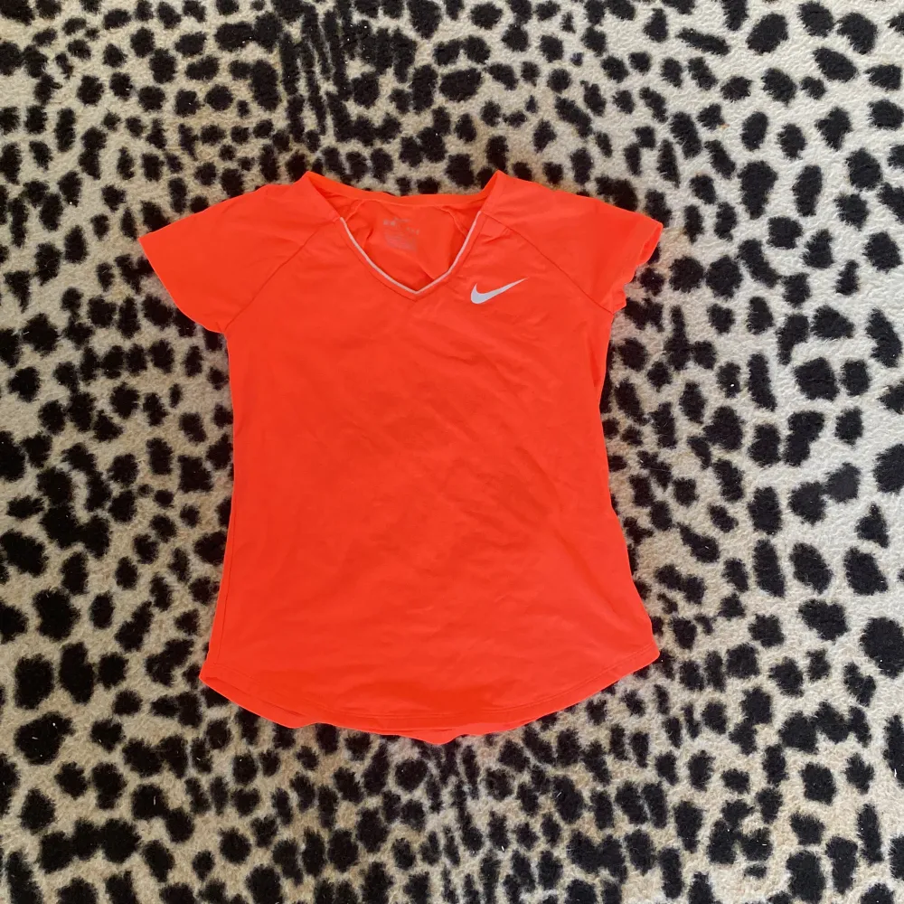 Så fin lys orange tröja från Nike❤️är i storlek 8-10 men är elastisk❤️. T-shirts.