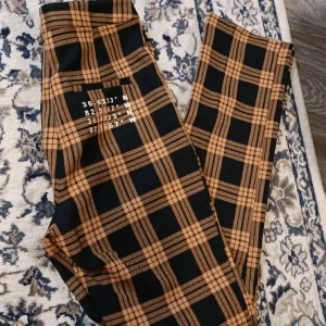 Rutiga kostymbyxor - Rutiga kostymbyxor  Orange,svart Raka ben  De är i modell tall