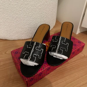 Tory Burch Sandaletter med klack - Köpta på NK i Stockholm. Lådan medföljer vid köp. Använda 1-2 gånger. Fler bilder kan skickas vid önskemål. De är i storlek 39 men passar även de med 38. 