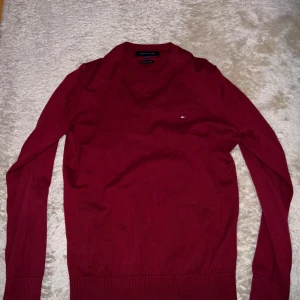 Tommy Hilfiger Sweatshirt Röd - Tommy Hilfiger Tröja Röd (V-neck). Knappt använd. Passar perfekt med skjorta under. Storlek S. Bara och skriva för fler frågor eller bilder!