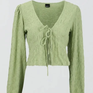 Långärmad magtröja från Gina Tricot - Väldigt fin långärmad tröja som kan justeras där fram genom att knyta hur tight man vill ha den.   ⭐️Aldrig använd  ⭐️Prislapp kvar  