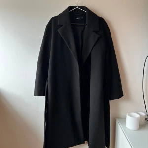 Svart kappa - Svart ganska lång kappa från Gina Tricot. Kommer aldrig till användning. Använd MAX 2-3ggr. 