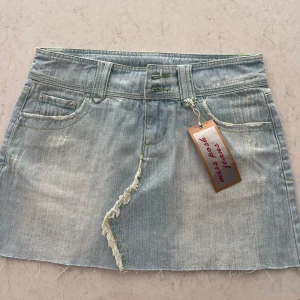 Jeanskjol - Vintage jeanskjol från en marknad i London. Super fin och unik i storlek 10 (motsvarande 34/36). Säljer då den inte riktigt passade mig🩵🌊🌈 Färgen visar sig mer grå på bild men den är väldigt ljus blå