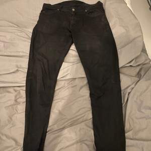Ett par svarta tiger of Sweden jeans i storlek 34x34
