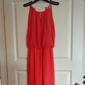 Klänning - Lång klänning i korall, storlek xs. Från Kappahl.