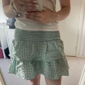 Grön rutig kjol  - grön volangkjol, köpt i Storbritannien och är i storlek 34 men skulle säga att den sitter som en 36