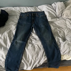 Levis Jeans Mörkblå - Säljer dessa snygga mörkblå par jeans från Levis. Modellen är 512. Köptes i New York 2022, kom sedan knappast till användning. Jeansen är i väldigt gott skick, inga hål eller liknande. Passformen är W30/L32. 