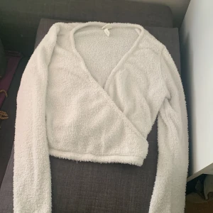 Vit lurvig Criss-Corss tröja - Vit lurvig Criss-Cross tröja som har jätte skönt material, lång armad mysig och jätte snygg såklart🤍🤍