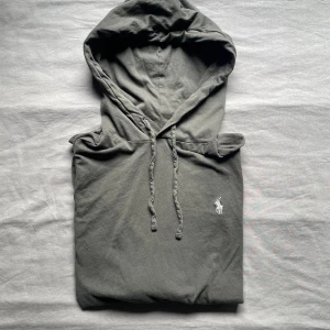 RALPH LAUREN HOODIE - Tjena säljer nu min tunna Ralph lauren tröja i mörkgrå färg med ett ljusgrått märke. Tröjan är i ett tunnare material och perfekt för sommaren. Storlek S men skulle säga att den passar för XS. Priset är inte hugget i sten, hör gärna av er vid frågor!