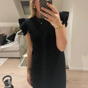 Klänning - Svart klänning med volang från zara, använd en gång! 