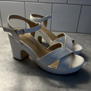 Vita klackskor  - Snygga och sköna vita klackar. Använda 2 gånger. Stl. 37. Nypris 550kr.