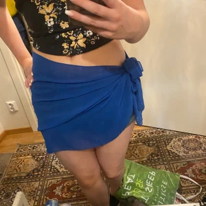 Beach coverup - Blå och svart cover up till stranden. Perfekt över din bikini. 💕jag har aldrig använt den. Man knyter den själv så passar de flesta.