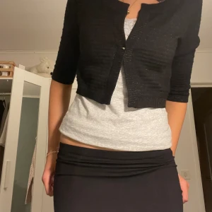 Bolero - Svart bolero. Har inga knappar men går att sy till.