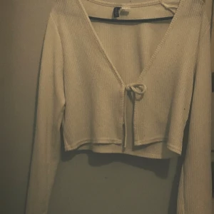 Vit kort knytten tröja - Har haft på mig den minst några gånger. Den är kort och knytten väldigt snygg går jätte bra med mid waist high waist elle low wastes jeans.Med en crop top elle vanlig topp💕💕. Storlek L fast väldigt liten ser inte alls stor ut 