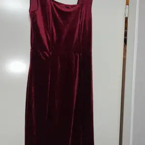 En vinröd sammet klänning oanvänd 