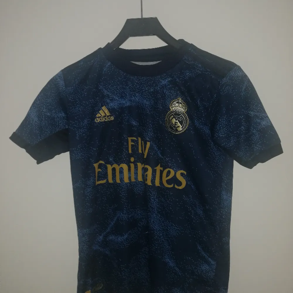 Säljer ett real Madrid set med tröja och shorts. Skicket är okej men använt. Nummer 7 på ryggen med Hazard. Storlek 164 så ungefär xs. T-shirts.