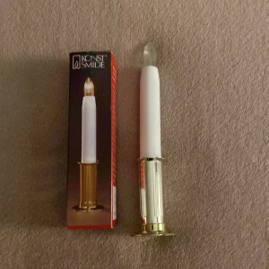 Lucia ljus från konst smide  - Lucialjus med guld  botten från konst smide. Batterier tillkommer ej. 