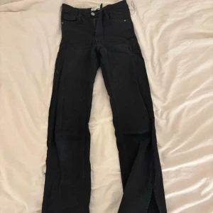 Svarta bootcut jeans - Svarta jeans med lite utsvävning och slit där nere i strl XXS köpta från GinaTricot. Ganska använda med fortfarande i bra skick säljer för att dom är för små för mig 🩷