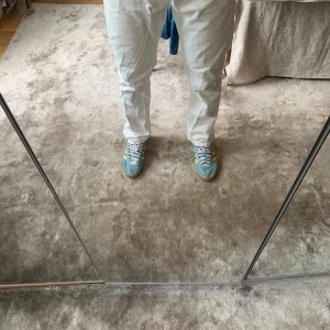 Vita jeans från Ralph Lauren - Säljer ett par fräscha vita jeans från Denim & Supply Ralph Lauren. Klassisk femficksmodell med raka ben och snygga detaljer som nitar och en liten amerikansk flagga vid fickan. Jeansen är i bomull och har en normal passform.