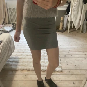 Grå kortkjol från Divided - Säljer en kort kjol  men råka ta kort åt fel håll så skicka om ni vill ha mer bilder.