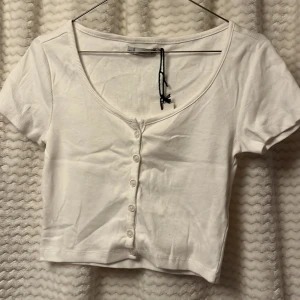 Helt ny Vit ribbad kortärmad topp från 157🤍 - Säljer en vit ribbad topp från 157 med korta ärmar och knappar framtill. 🌸
