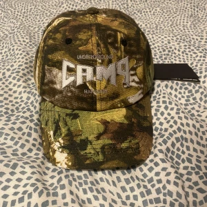 MUDG underground camp rangers keps - Sällsynt MUDG camp rangers keps i camo. oanvänd, inte tagit bort lapp / plasten i bak. 
