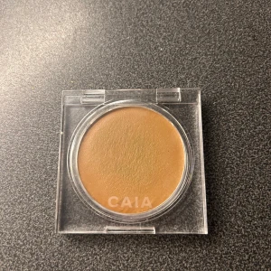 CAIA Soft Melt Bronzing Balm Maui - Bronzer i nyansen Maui från CAIA. Krämig formula i en rund, transparent dosa. Ger en varm, solkysst look med naturlig finish. Perfekt för att skulptera ansiktet eller addera glow. Innehåller 8g produkt.
