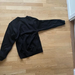 Svart sweatshirt - Säljer en klassisk svart sweatshirt med rund hals och långa ärmar. Perfekt för en avslappnad stil. Passar bra till jeans eller joggers.