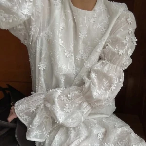 Vit blommig klänning med volang och öppen rygg - Superfin vit klänning med broderade blommor, volang nertill och långa puffärmar. Baksidan har en djup v-ringning med knytband. Perfekt för sommarens alla tillfällen, speciellt till studenten eller midsommar 🤍🤍🤍