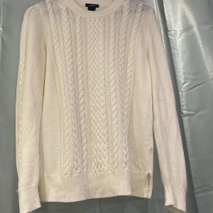 Vit stickad tröja  - Säljer en vit stickad tröja från Lindex med  flätmönster både fram och på ärmarna. Tröjan har rund halsringning och långa ärmar.💓