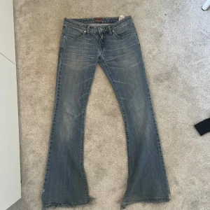 Blå bootcut jeans från Big Star - Snygga blå bootcut jeans från Big Star med klassisk femficksdesign. Jeansen har en lågmidjad passform och är perfekta för en avslappnad stil. Tillverkade i jeansmaterial med en lätt tvättad look. Slitna där nere så ha det i åtanke! ( syns inte på bilden men skriv privat för bild!! )