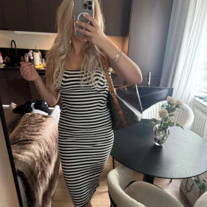 Randig ribbad klänning - Säljer en svartvit, ribbad klänning med tight men skön passform. Klänningen är knälång, utan axelband och har ett klassiskt randigt mönster🫶🏼