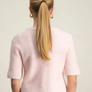 Ljusrosa stickad kofta med kort ärm - Superfin ljusrosa stickad kofta med korta ärmar och rund hals. Koftan har en rak passform och stängs med knappar framtill. Perfekt att slänga över en topp för en söt och chill look.