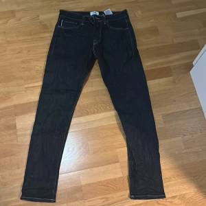 Mörkblå jeans från R.D.D. 32/32 - Snygga mörkblå jeans från R.D.D. i klassisk femficksmodell. Jeansen har kontrastsömmar och raka ben med en något smalare passform. Perfekta för dig som gillar stilrena och tidlösa jeans i denim.