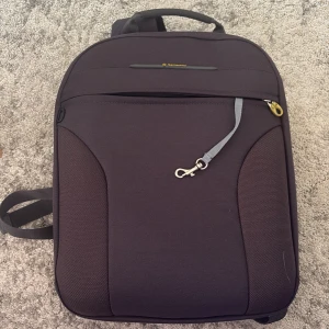 Svart ryggsäck från Samsonite - Säljer en stilren svart ryggsäck från Samsonite med vadderade axelremmar, praktiskt bärhandtag och flera fack, inklusive vadderat laptopfack och meshficka med dragkedja. Perfekt för skola eller jobb och rymmer allt du behöver till vardagen.