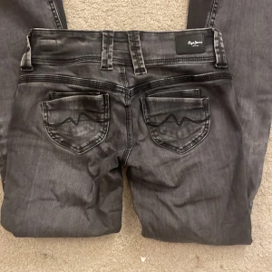 Svarta långmidjade jeans från Pepe Jeans - Snygga svarta jeans från Pepe Jeans. Midjemåttet är 36cm och innerbenslängden 77cm . Däremot är de stretchiga och passade mig som brukar ha större storlek💕