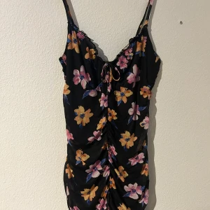 Fin sommarklänning - En jättefin blommig kort sommarklänning! Tight på rätt ställen och har en fin urringning🩷