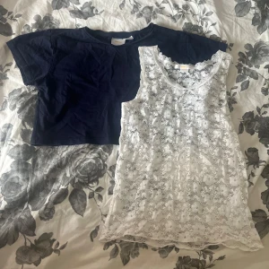 2-pack toppar från Gina Tricot spets & marin - Säljer två snygga toppar från Gina Tricot i storlek 146/152. Ena är en marinblå croppad t-shirt i bomull, den andra är en vit linnetopp i spets med blommigt mönster. Den är populär och den finns inte o köpa längre på Gina, därav priset.