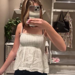 Vit glittrig linnetopp - Säljer en söt vit linnetopp med tunna axelband och glittriga detaljer. Perfekt för varma dagar eller när du vill känna dig extra fin. Själv använd på nyår och även som kjol vid vissa tillfällen då banden går att ta av. Nypris 200 ish (går ej att hitta på hemsidan). Priset går att diskutera🥰