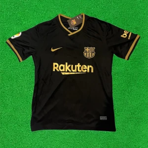 Svart FC Barcelona fotbollströja med guldiga detaljer - Snygg svart FC Barcelona matchtröja från Nike med guldiga detaljer och loggor. Rakuten och UNICEF-tryck, klubbmärke på bröstet och La Liga-märke på ärmen. Perfekt för dig som älskar Barca och vill sticka ut på planen.